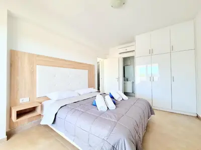a bedroom with a large bed with two pillows on it at The 4th Seaview Villas in Kiotari