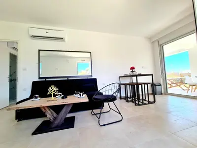 a living room with a table and a couch at The 4th Seaview Villas in Kiotari