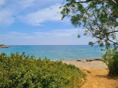 a view of the ocean from a sandy beach at The 4th Seaview Villas in Kiotari