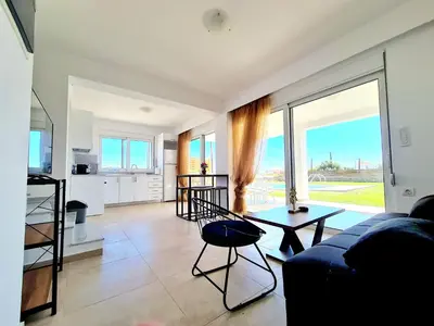 a living room with a couch and a table at The 4th Seaview Villas in Kiotari