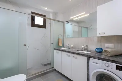 a bathroom with a washing machine and a washer at Rodini Anassa in Rhodes Town