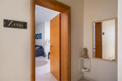 a hallway with a door and a mirror in a room at Rodini Anassa in Rhodes Town