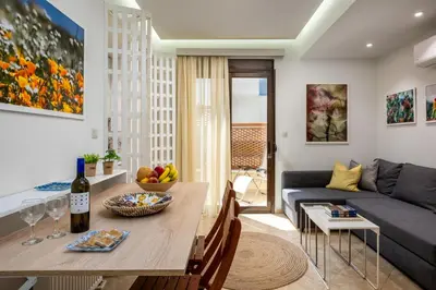a living room with a table and a couch at Rodini Anassa in Rhodes Town