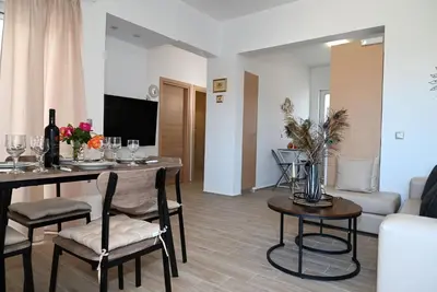 a living room with a table and chairs and a couch at Filerimos City Center Apt in Ialysos Rhodes in Ialyssos