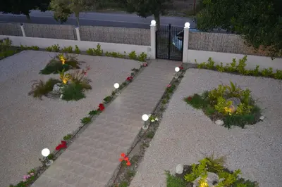 a garden with flowers and a brick walkway at Azure Dreams Villa with pool - Haraki beach in Haraki