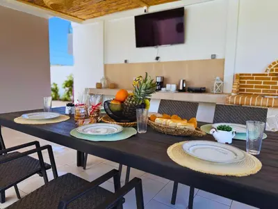 a table with plates and fruit on it in a kitchen at Azure Dreams Villa with pool - Haraki beach in Haraki
