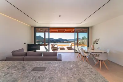 a living room with a couch and a table at Under The Sun on Faliraki Hill in Kalithies