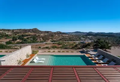 a view from the roof of a house with a swimming pool at Under The Sun on Faliraki Hill in Kalithies