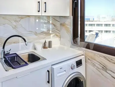 a kitchen with a sink and a washing machine at 7-Modern city center studio with sea view! in Rhodes Town