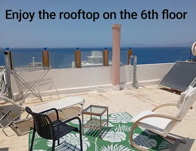 a patio with two chairs and a table and a table and chairs at 7-Modern city center studio with sea view! in Rhodes Town