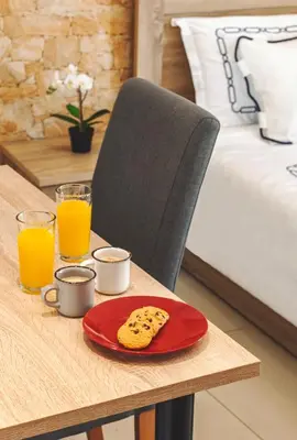 a table with a red plate with cookies on it at 5- Luxury suite for 4 in the most central part of Rhodes! in Rhodes Town