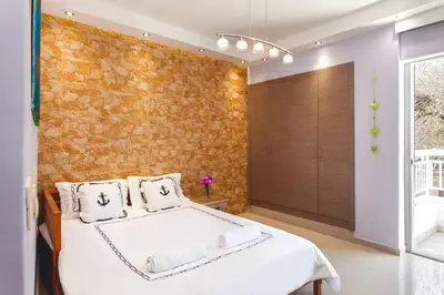 a bedroom with a brick wall and a bed at 5- Luxury suite for 4 in the most central part of Rhodes! in Rhodes Town