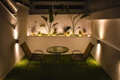 a table and chairs in a room with plants at Melograno di Rodi 7 in Rhodes Town