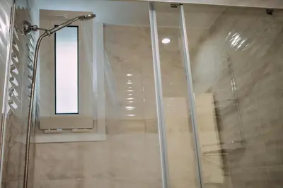 a shower with a glass door and a window at Melograno di Rodi 7 in Rhodes Town