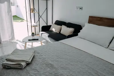 a bedroom with a bed and a couch at Melograno di Rodi 7 in Rhodes Town