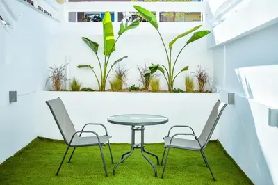 a table and two chairs in a room with plants at Melograno di Rodi 7 in Rhodes Town