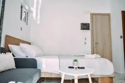 a bedroom with a bed with a table and a couch at Melograno di Rodi 7 in Rhodes Town