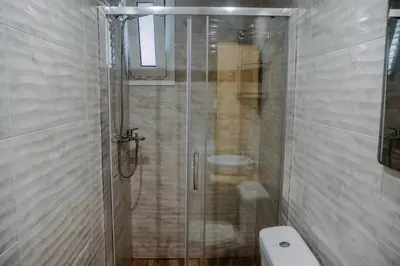 a bathroom with a glass shower with a toilet at Melograno di Rodi 7 in Rhodes Town