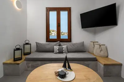 a living room with a couch and a table at Evgenias Sea House in Symi