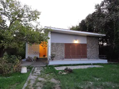 a small house in a yard with a grass yard at Summerhouse Marianna in Ixia