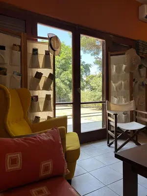a living room with a yellow couch and a window at Summerhouse Marianna in Ixia