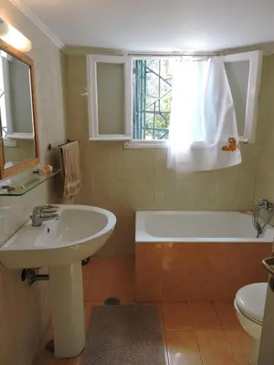 a bathroom with a sink and a tub and a toilet at Summerhouse Marianna in Ixia