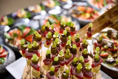 a group of food on sticks with grapes on them at Blue Bay Beach Resort in Ialyssos