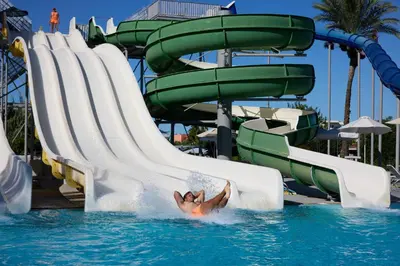 a person in the water on a water slide at a resort at Blue Bay Beach Resort in Ialyssos