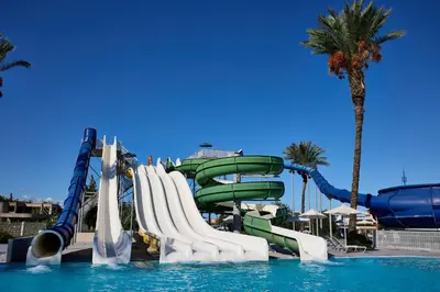 a water slide in a swimming pool in a resort at Blue Bay Beach Resort in Ialyssos