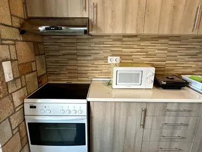 a kitchen with a stove and a microwave on a counter at Stone House Retreat in Kalavárda