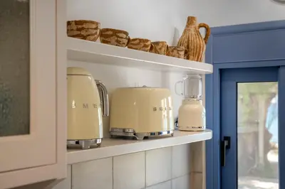 a shelf with two coffee makers and bread at Hermes Seaview House in Archangelos