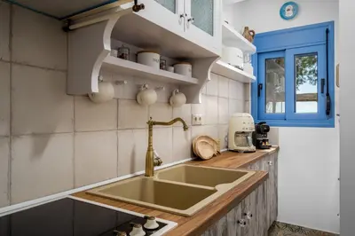 a kitchen with a sink and a window at Hermes Seaview House in Archangelos