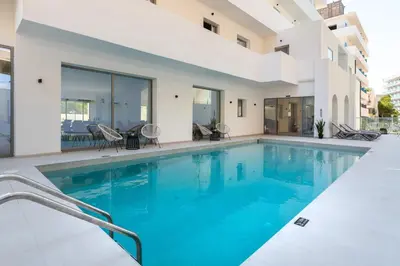 a swimming pool in the middle of a house at Rodos White in Rhodes Town
