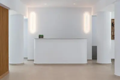 a large white table in a room with white walls at Rodos White in Rhodes Town