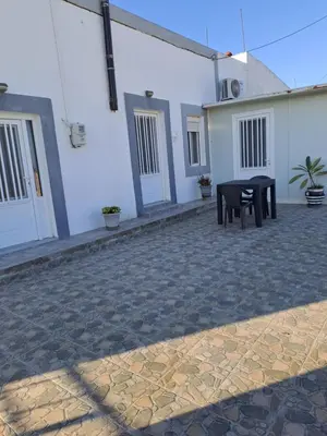 a ping pong table in the courtyard of a building at House of Happiness in Kritinía