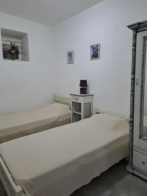 a room with two beds and a table with a counter at House of Happiness in Kritinía