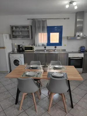 a kitchen with a wooden table and chairs in it at Villa Amalia in Vrachonisída touArchangélou