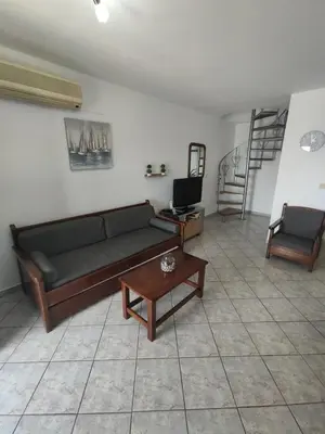 a living room with a couch and a table at Villa Amalia in Vrachonisída touArchangélou