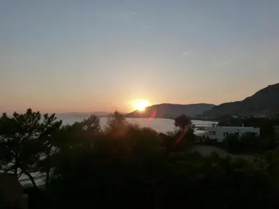a sunset over the water with the sun in the sky at Evi Studios & Apartments Pefkos in Pefki Rhodes