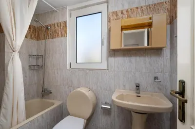 a bathroom with a sink and a toilet and a bath tub at Evi Studios & Apartments Pefkos in Pefki Rhodes