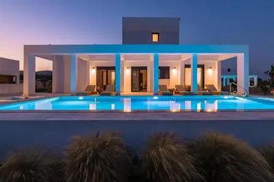 a villa with a swimming pool at night at Seashell Villa - Luxury Pool Retreat - 150m Beach in Lachania