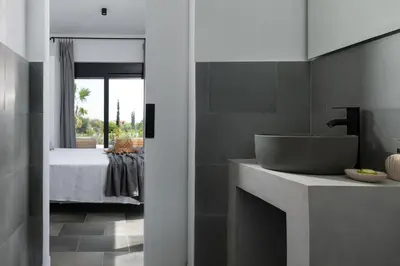 a bathroom with a sink and a bathroom with a bed at Seashell Villa - Luxury Pool Retreat - 150m Beach in Lachania