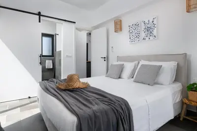 a bedroom with a white bed with a hat on it at Seashell Villa - Luxury Pool Retreat - 150m Beach in Lachania