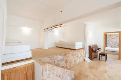 a bedroom with two beds and a desk with a bed at Rhodes Retreat in Kalithies