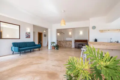 a living room with a blue couch and a table at Rhodes Retreat in Kalithies