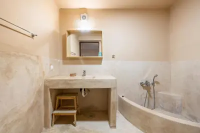a bathroom with a sink and a bath tub at Rhodes Retreat in Kalithies
