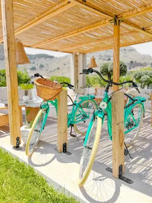 two bikes are parked under a wooden shelter at LA Casa Di Lusso Casa N1 Adults Only in Kolimbia