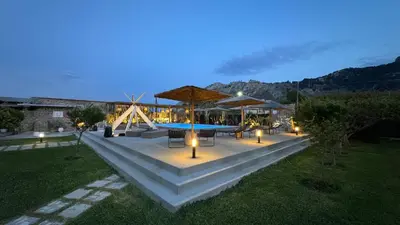 a patio with a table and chairs and a pool at LA Casa Di Lusso Casa N1 Adults Only in Kolimbia
