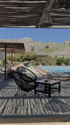 a patio with a bench and a table and a pool at LA Casa Di Lusso Casa N1 Adults Only in Kolimbia