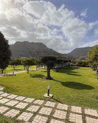 a park with a tree in the middle of a field at LA Casa Di Lusso Casa N1 Adults Only in Kolimbia